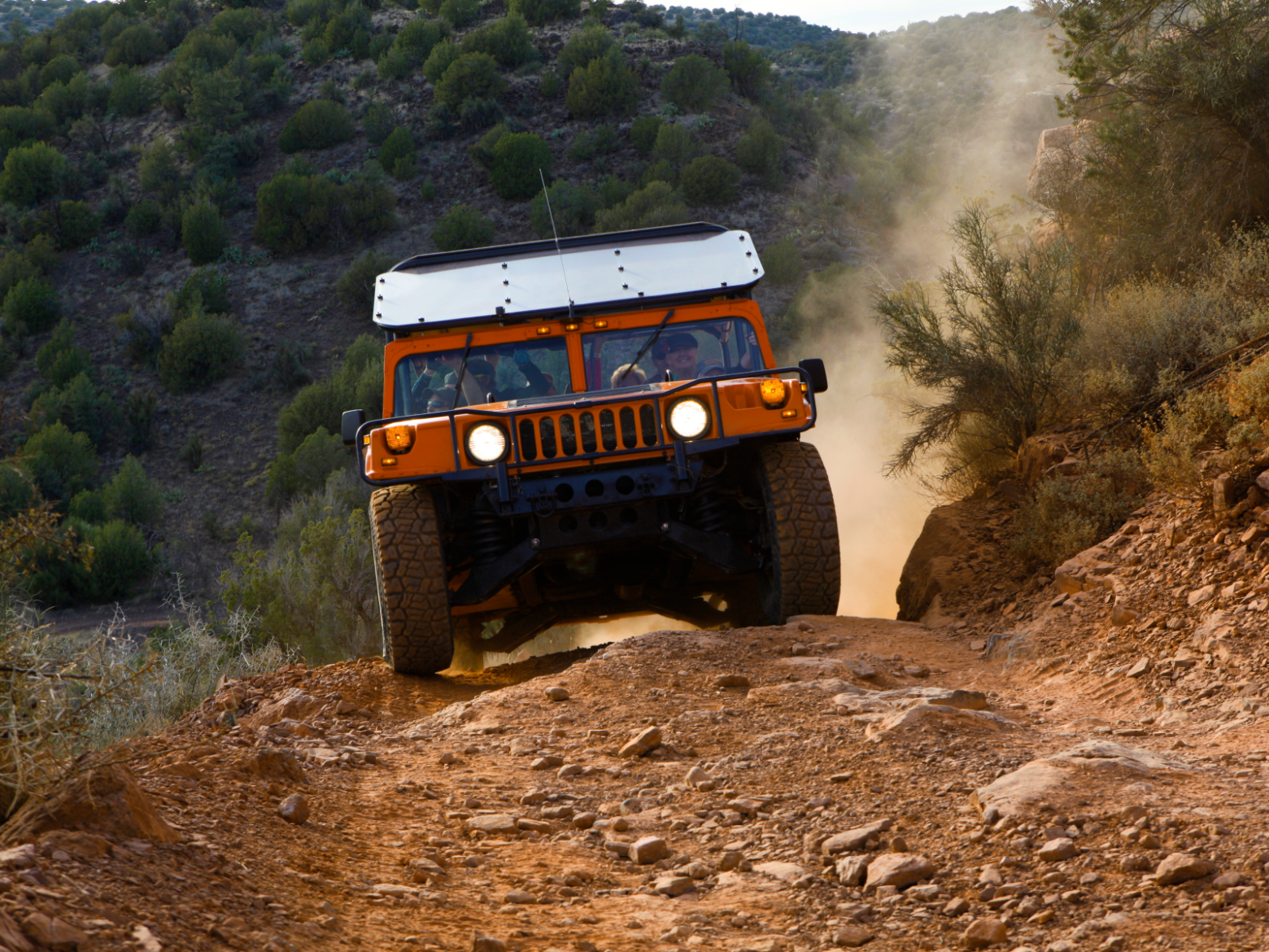 red jeep driving on rugged terrain