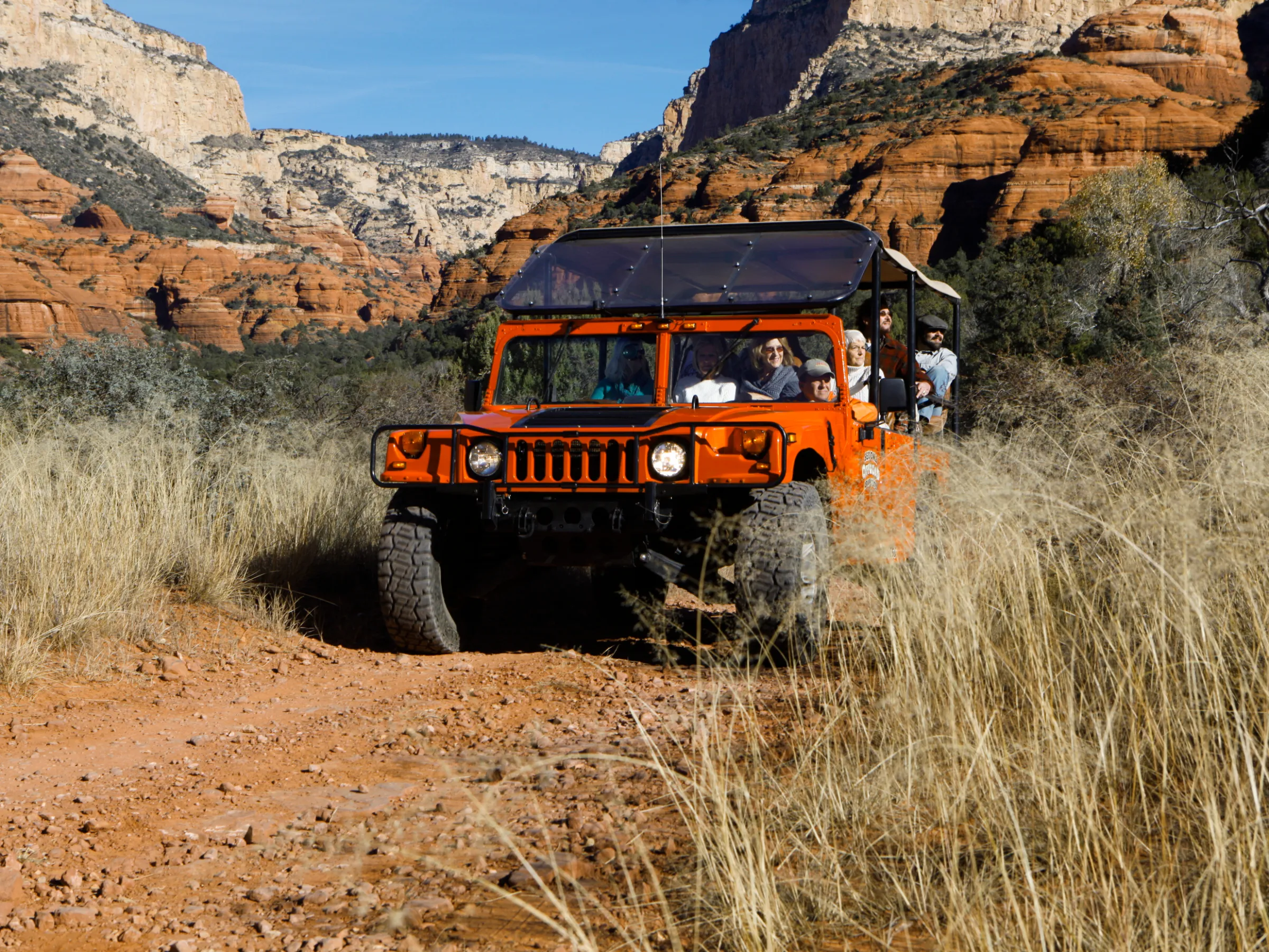 red jeep driving on rugged terrain