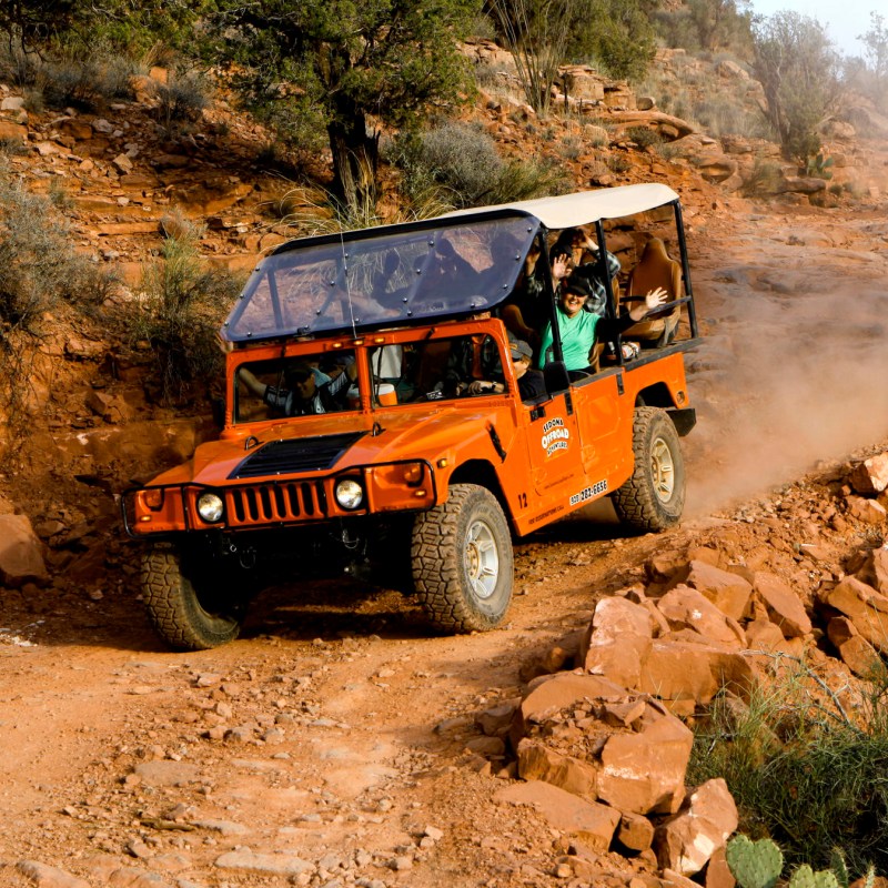 orange hummer driving rugged trail in sedona